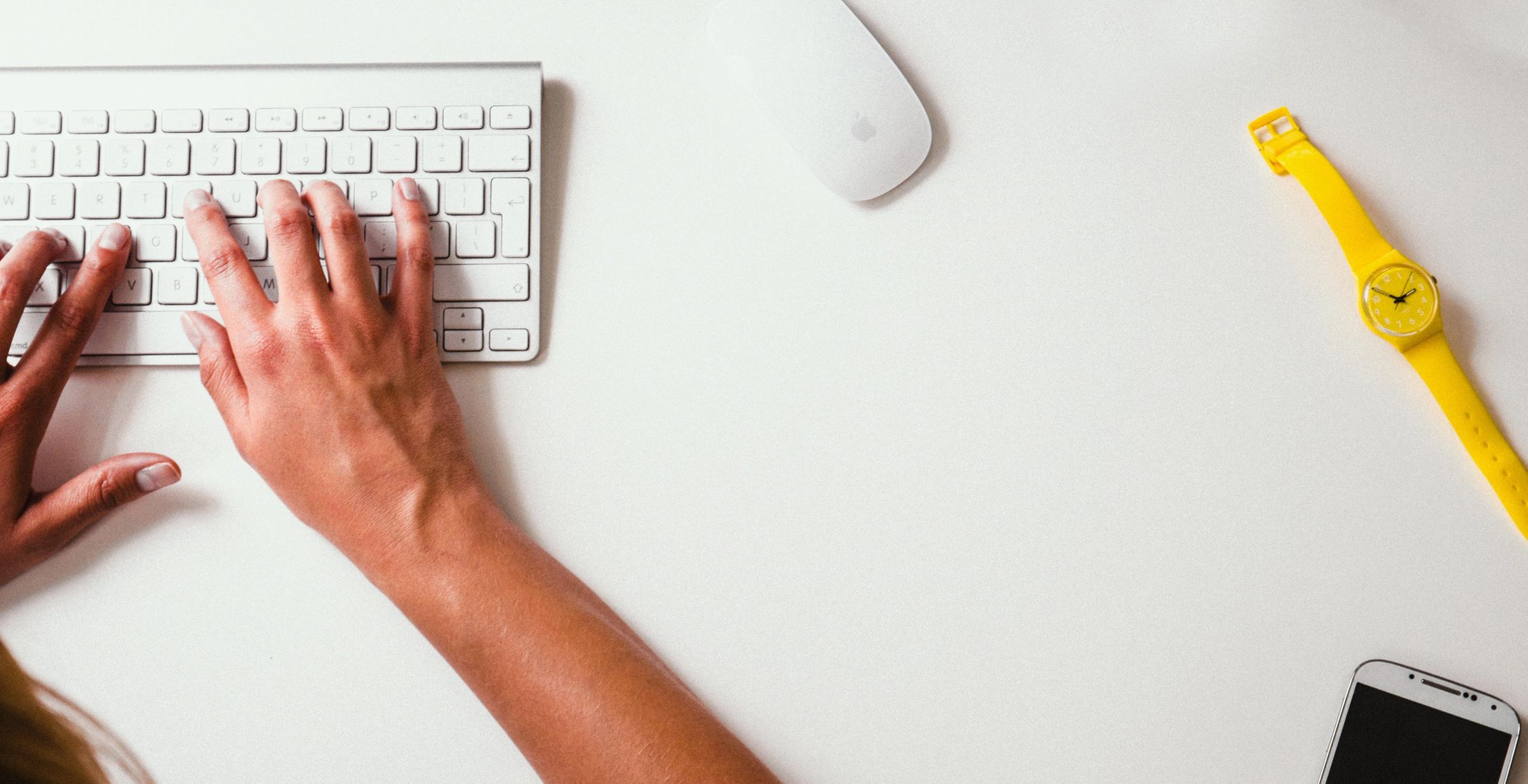 hands typing on wireless keyboard